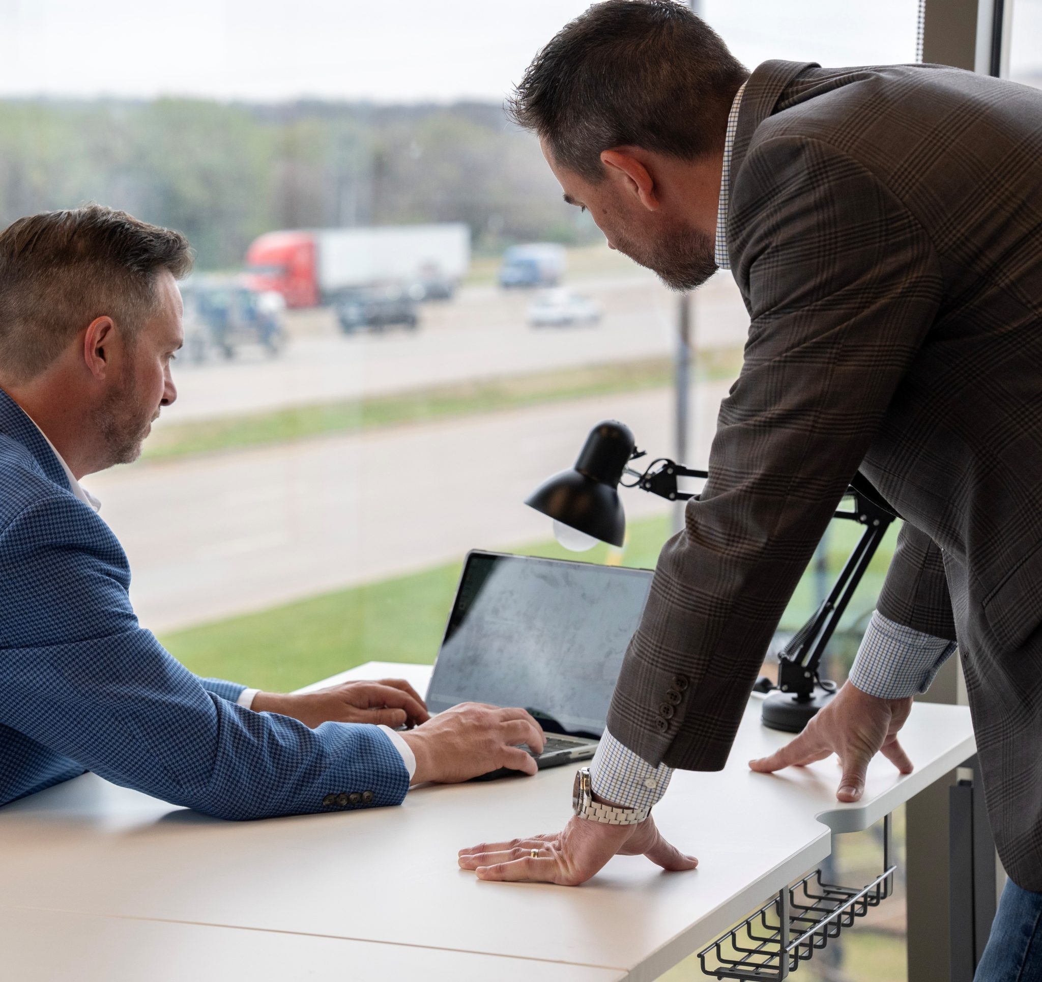 Attorneys Brett Chandler and John "Tony" Ross looking over a laptop